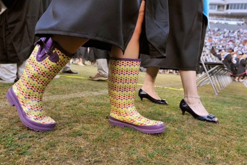 feet of graduate wearing rain boots